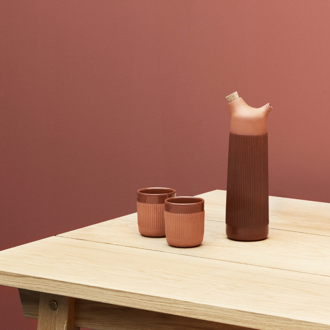 The Junto Carafe by Normann Copenhagen was inspired by traditional Spanish ceramics in a beautiful fired terracotta. We love the organic shape of the handmade stoneware, which creates the perfect spout for pouring water or juice from the carafe.