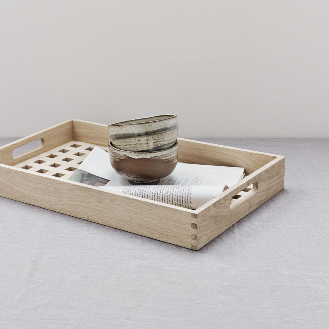 The Skagerak Fionia Tray is a modern, rectangular tray that can be used in a variety of spots throughout the home. We love it styled on a bed side table or bench at the base of a bed, but it can also be used when hosting guests outdoors or in the dining room. It's beautiful and simplistic, and will quickly become an item you use often.